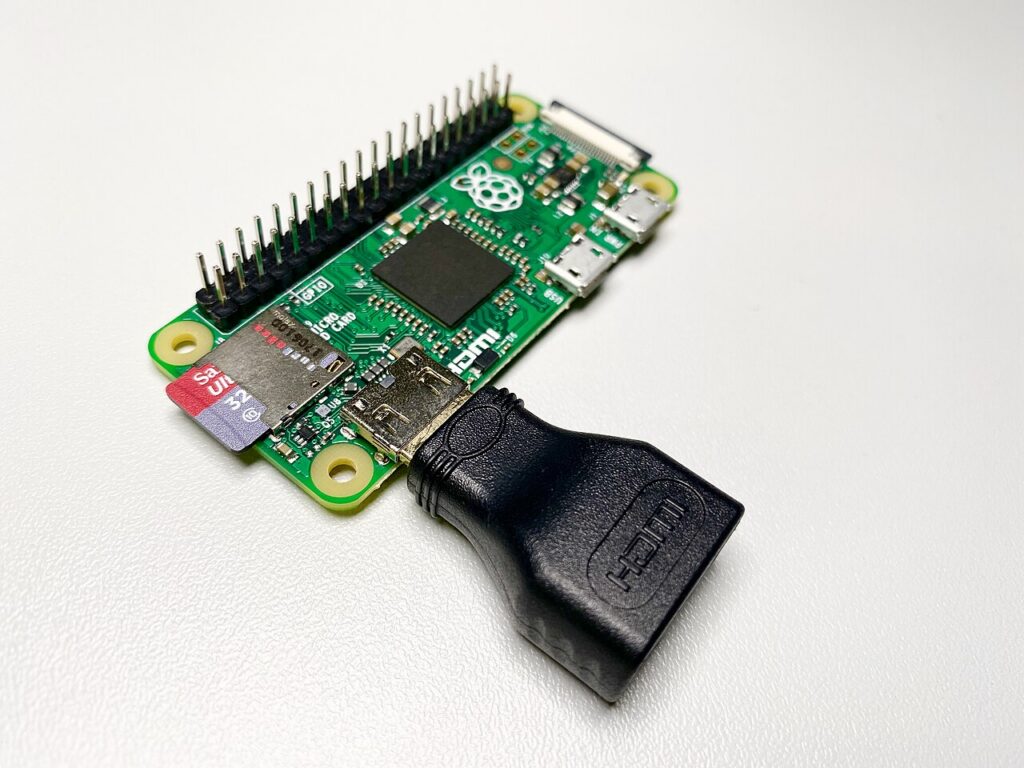 microSD 카드와 미니 HDMI 어댑터가 꽂힌 라즈베리 파이 Zero 보드와 GPIO 핀