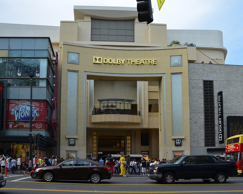 금색 DOLBY THEATRE 간판이 달린 돌비 극장 정면과 앞 도로의 차량·보행자